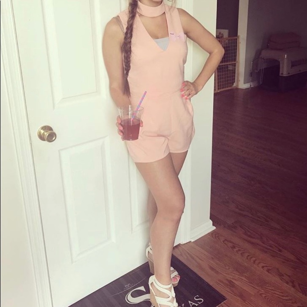 Pink romper with collar .